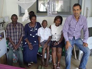 Nelson with his dad and two carers at the Uganda hospital
